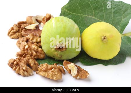 Fresh Yellow Green Figs and walnuts with Fig Leaf Isolated on White Background Stock Photo