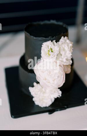Elegant Black Wedding Cake with White Flowers Stock Photo