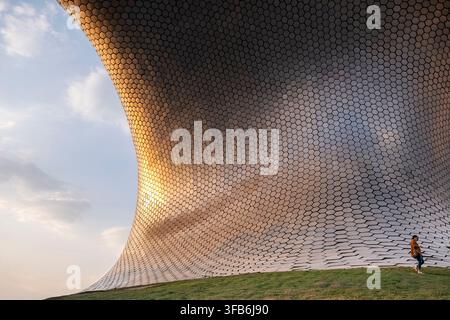 Woman Standing Beside Museo Soumaya Hexagonal Facade. Mexico City Stock Photo