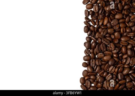 Roasted coffee beans against a white background with copy space for text. Stock Photo