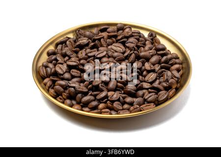 Roasted coffee beans piled on a round gold metal plate isolated on a white background. Stock Photo