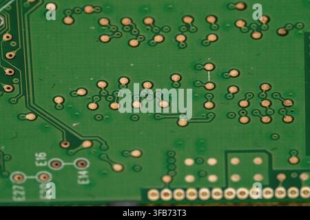 A close view of a circuit board reveals the arrangement of electronic connections and pathways. This image shows the complex design used in electronic Stock Photo