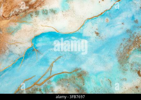 Abstract fluid art painting in turquoise blue and gold with cracked veins and sandy brown edges, resembling a marbled stone surface or an aerial view Stock Photo