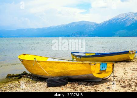 Wooden fishing rowing boats moored on the beach of Lake Ohrid - Pogradec, Albania Stock Photo