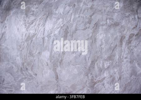 Abstract gray concrete wall with natural plaster marks and uneven surface creating a neutral industrial texture ideal for backgrounds architecture des Stock Photo