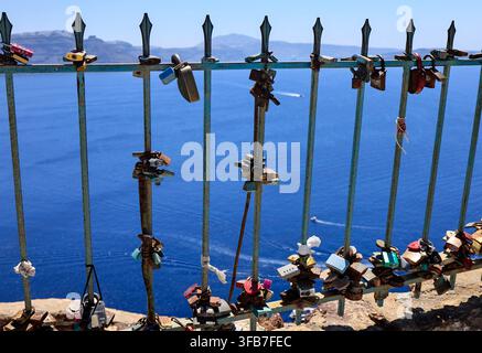 Rusty love locks on a railing overlooking the sea, Santorini, Greece Stock Photo