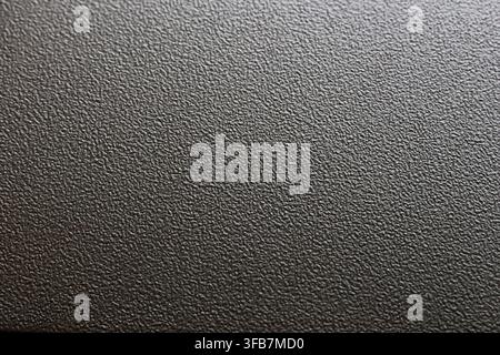 A black textured surface with fine grain pattern, dark background, and tactile material detail for abstract design use Stock Photo