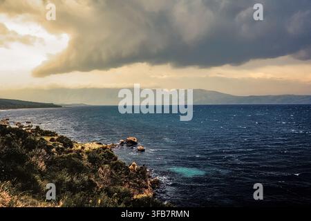Dramatic storm clouds over the Adriatic Sea and rugged rocky coastline of the Gulf of Vlora. Vlorë, Vlorë County, Albania, Europe Stock Photo