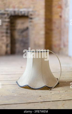 Vintage lampshade on wooden floor during home renovation Stock Photo