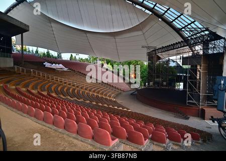 Outdoor Amphitheater With Covered Stage And Tiered Red Seating Ready For Concert Performance In Music Festival " Picnic Country" - Mrągowo. Stock Photo