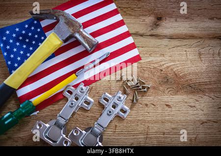 Labor Day concept. American flag and different working construction tools on dark wooden background. Hand tools with Flag of the United States of Amer Stock Photo
