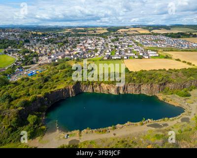 Aerial view of a residential area in a small town surrounded by lush ...