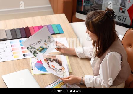Interior design and home renovation concept, female designer working on new project with fabric samples and sketches Stock Photo