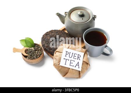 Dry pressed puer leaves with teapot, cup of tea and sticky note on white background Stock Photo
