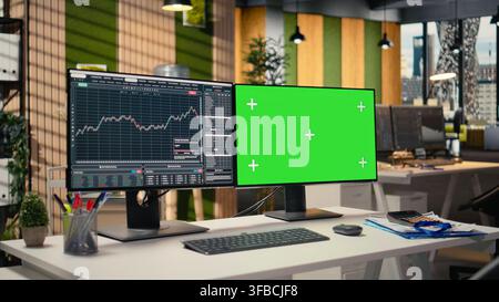 Green screen PC displaying stock market graphs in proprietary firm office. Chroma key PC on brokerage workspace desk used for stock exchange analysis and strategy planning Stock Photo