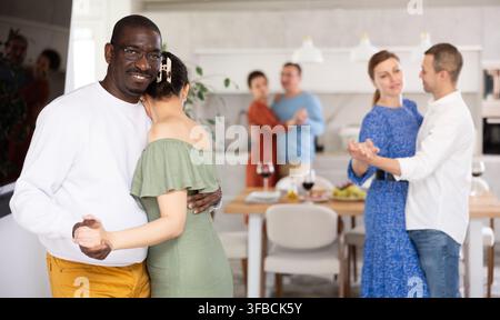 Black man enjoying slow dance with woman at house party Stock Photo