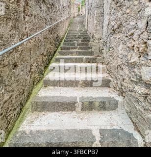 historic stone staircase pedestrian path between masonry walls in ravello Stock Photo