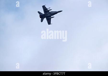 Fighter jet flying in cloudy sky. Stock Photo