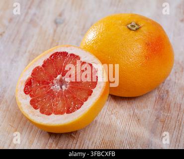 Sliced grapefruit on wooden table Stock Photo