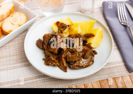 Fried rabbit liver served with boiled potato Stock Photo