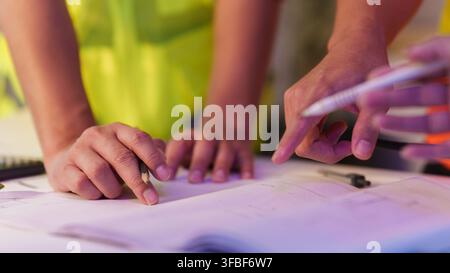 Engineers hands reviewing blueprint on desk for construction project planning Stock Photo