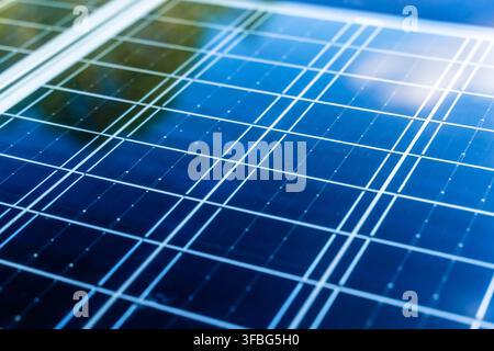 Solar panel surface background close-up. Solar technology concept. Detailed macro shot of a modern blue photovoltaic solar panel surface, highlighting the grid pattern, semiconductor cells, and technology used for clean and renewable energy generation. Stock Photo