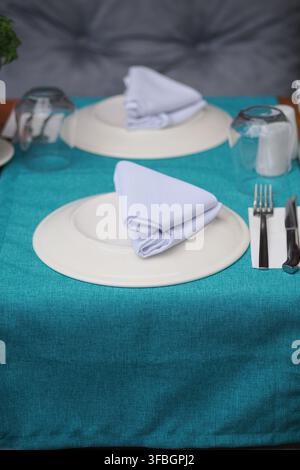 Table set for dining with cloth and utensils Stock Photo
