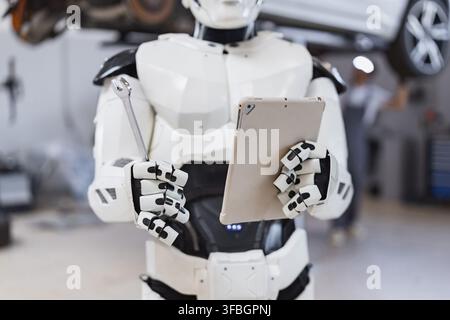 Robot Holding Wrench and Tablet Stock Photo
