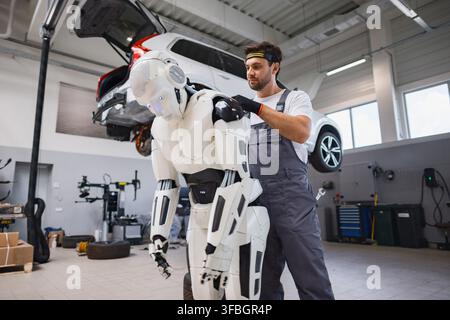 Mechanic Working On Robot Stock Photo