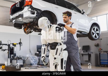 Mechanic Working On Robot Stock Photo