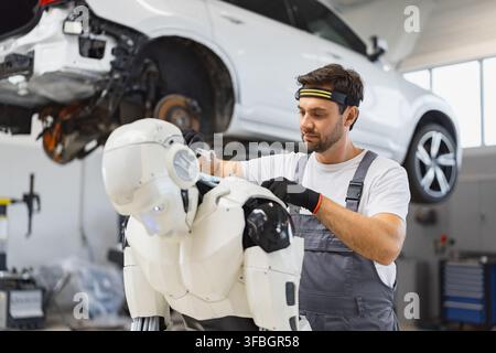 Mechanic Working On Robot Stock Photo