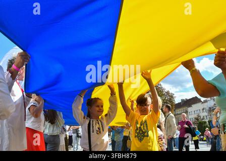 Ukrainians hold national flag a 35-meter long during a public event to mark National Flag Day in Lviv, western Ukraine, 23 August 2026. National Flag Day is celebrated annually in Ukraine on 23 August, honoring one of the country's main state symbols. Stock Photo