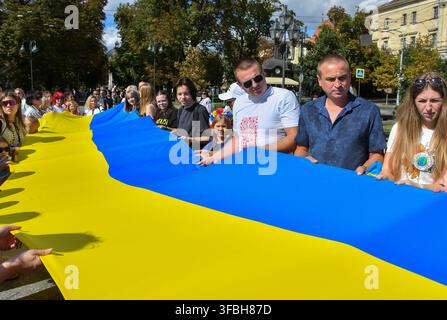 Ukrainians hold national flag a 35-meter long during a public event to mark National Flag Day in Lviv, western Ukraine, 23 August 2026. National Flag Day is celebrated annually in Ukraine on 23 August, honoring one of the country's main state symbols. Stock Photo