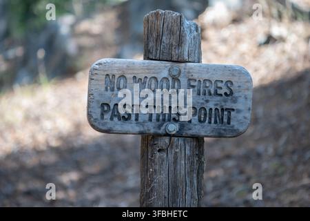 A wooden sign warning hikers that No Wood Fires Past this Point are allowed in Inyo National Forest, California, USA. Stock Photo