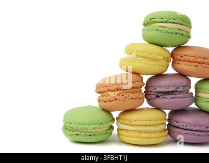 Round baked multi-colored almond flour cakes macarons, dessert is laid in a stack in the shape of a triangle and isolated on a white background Stock Photo