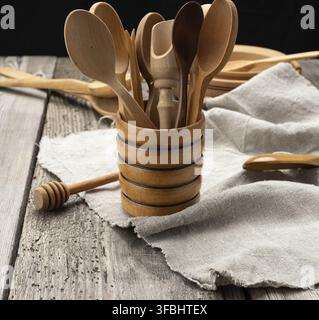 Empty round wooden plates and spoons on a gray table Stock Photo