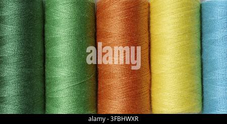 Multicolored spools of sewing threads, top view Stock Photo