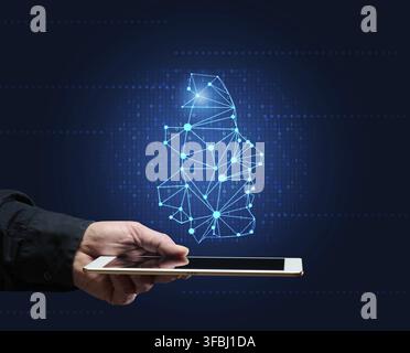 Male hand holds a tablet and a holographic drawing of a robot head. The concept of learning artificial intelligence to improve search engines, applica Stock Photo