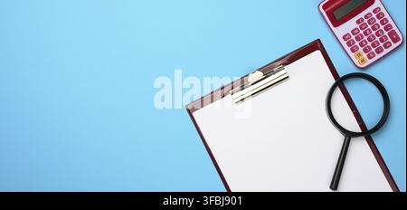 Pink calculator, folder with blank white sheets and black magnifier on a blue background. Banner for business, top view Stock Photo