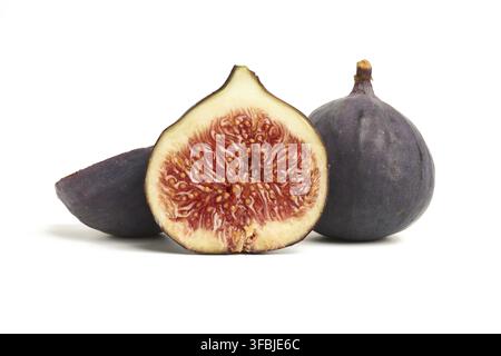 Ripe whole and halved purple figs isolated on white background, close up Stock Photo