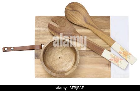 Wooden kitchen cutting board, spoons and an empty bowl on a white isolated background, top view Stock Photo
