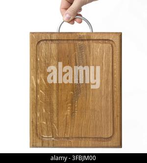 Female hands hold empty rectangular brown wooden chopping board on white background Stock Photo