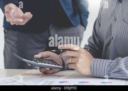 Two cheerful entrepreneur colleagues smiling while discussing or Talking about ideas of the new work project Stock Photo