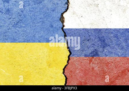 Faded Ukraine VS Russia national flags icon isolated on broken weathered cracked concrete wall background, abstract Ukraine Russia politics economy re Stock Photo
