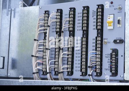 Electric control panel. The wires are connected to residual current circuit breakers and voltage monitoring relays. Stock Photo