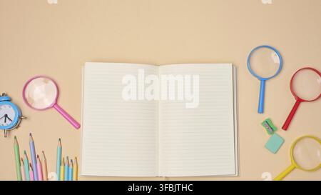 Top view of an open notebook with pastel-colored pencils, green sharpener, and turquoise eraser on a beige background. Flat lay composition of school Stock Photo