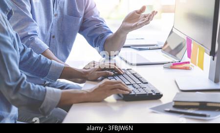 Young startup Programmers Sitting At Desks Working On Computers screen for Developing programming and coding to find solution to problem on New Applic Stock Photo
