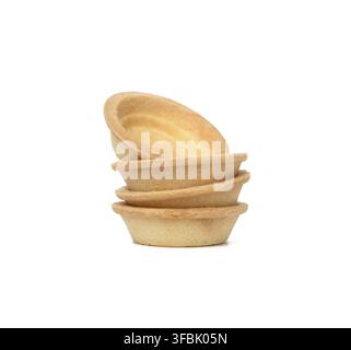 Stack of empty baked round canape baskets isolated on white background, close up Stock Photo