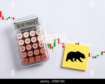 Calculator displaying bear market with a bear silhouette on a sticky note, symbolizing financial downturn and economic recession Stock Photo