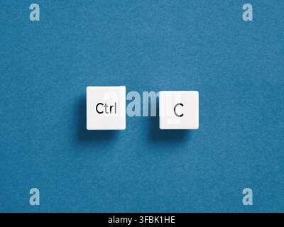 Two white keyboard keys on a blue background symbolizing the common Ctrl plus C shortcut for copying text or data Stock Photo